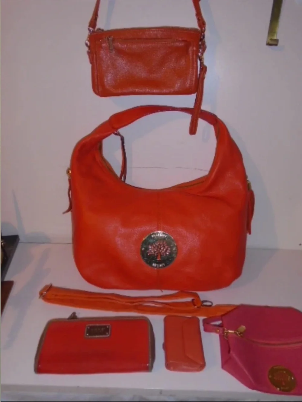 Mulberry Orange Leather Hobo Bag with Tassels and Gold Emblem